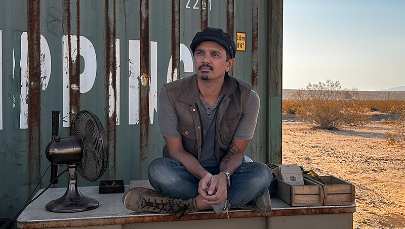 Author Anthony "Scout" Underwood seated at the Scoutpost shipping container in the Joshua Tree desert