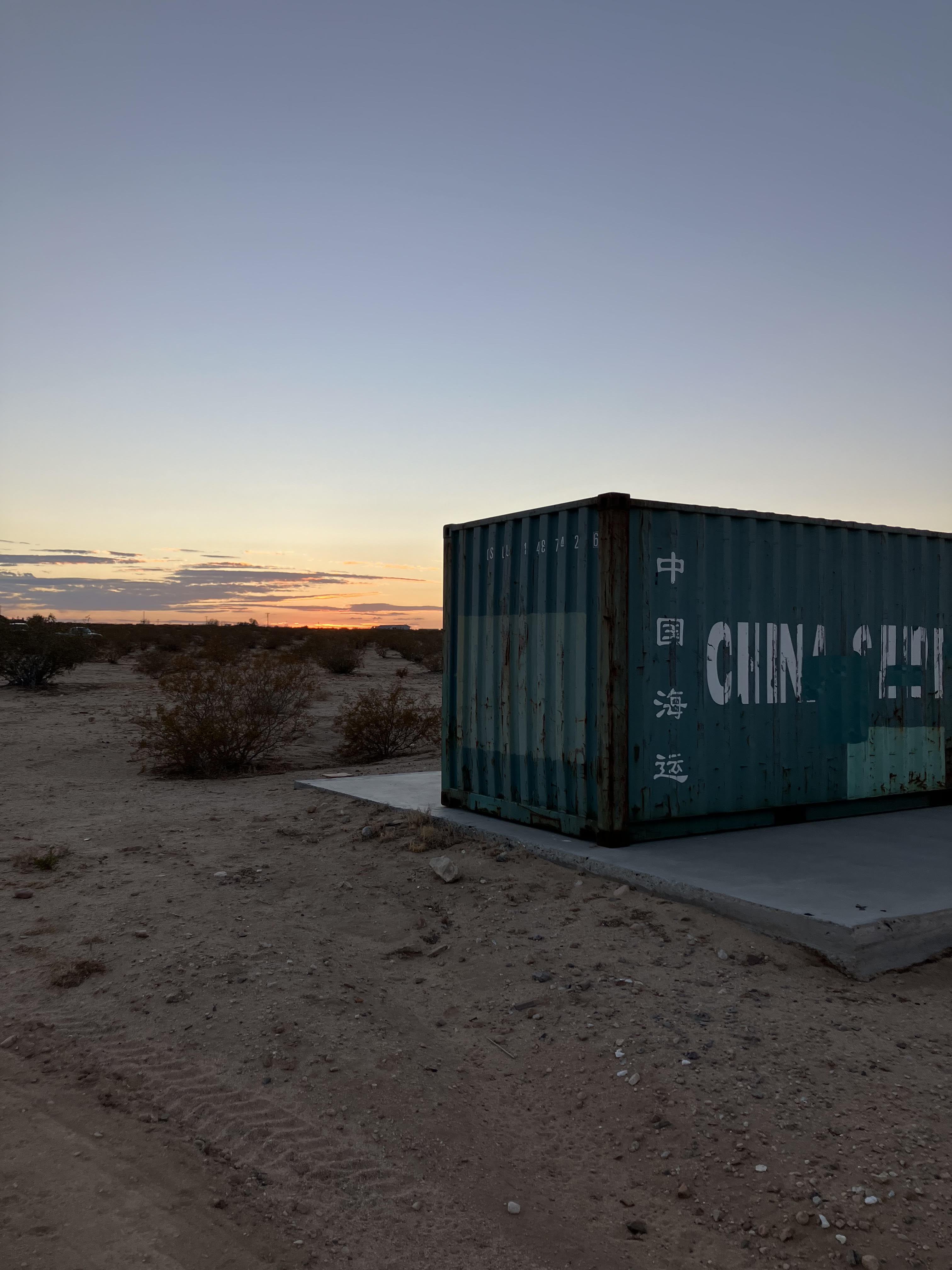 The real Scoutpost shipping container at sunset in the Joshua Tree desert
